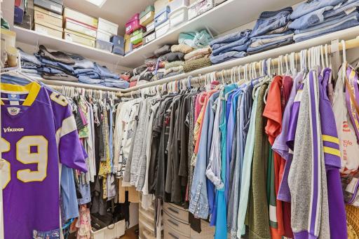 Large walk in closet with added double shelf for extra storage.