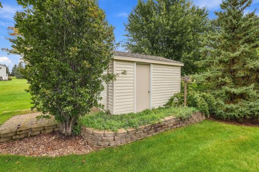 Spacious storage shed with roll front door, side service door