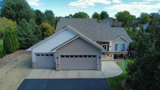 Aerial photo of primary front, mature pine trees framing back yard for privacy. Extensive professional landscaping and in-ground irrigation.