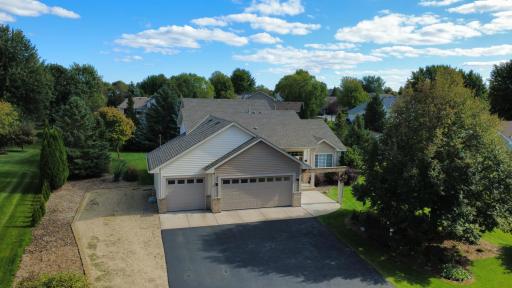 Aerial photo of primary front, mature pine trees framing back yard for privacy. Extensive professional landscaping and in-ground irrigation.