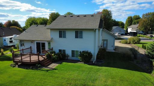 Back of home. Amazingly private backyard surrounded by mature pine trees, entertain & relax with backyard fire pit.