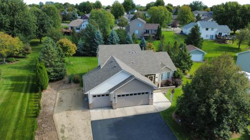 Aerial photo of primary front, mature pine trees framing back yard for privacy. Extensive professional landscaping and in-ground irrigation.