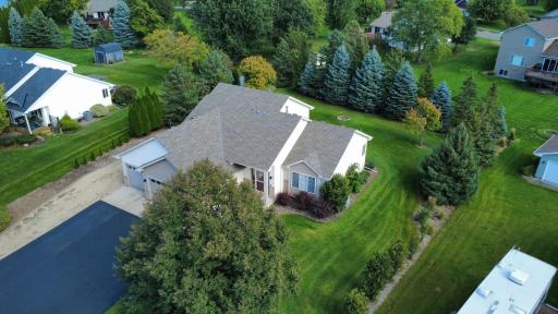 Aerial photo of primary front, mature pine trees framing back yard for privacy. Extensive professional landscaping and in-ground irrigation.