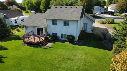 Spacious deck off of kitchen dining area, back service door off of garage, additional parking pad on side of garage with 30 amp camper/trailer hook up.