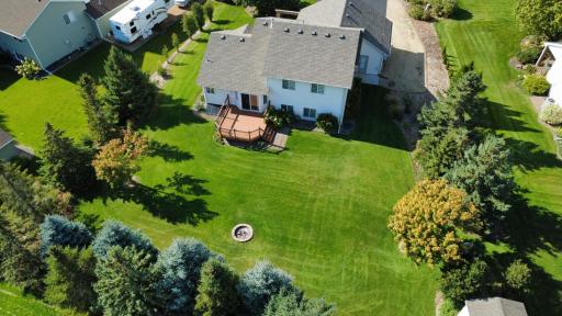 Amazingly private backyard surrounded by mature pine trees, entertain & relax with backyard fire pit.
