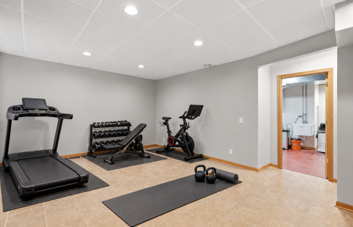 Basement level flex room with egress window, tile flooring, egress window (virtually staged)