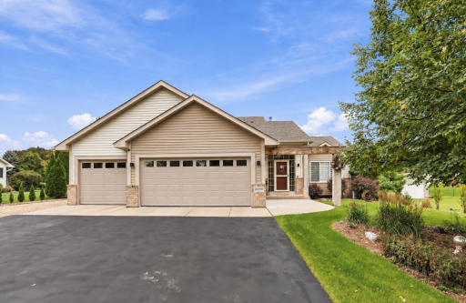 Primary front photo, extra wide driveway with concrete apron, additional parking space on side of garage with 30 amp camper/trailer connectivity.