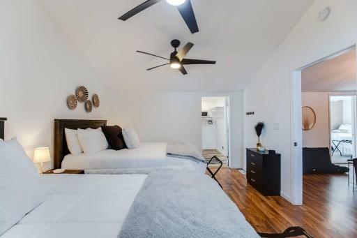 Generously sized bedroom with vaulted ceilings and room for multiple beds.