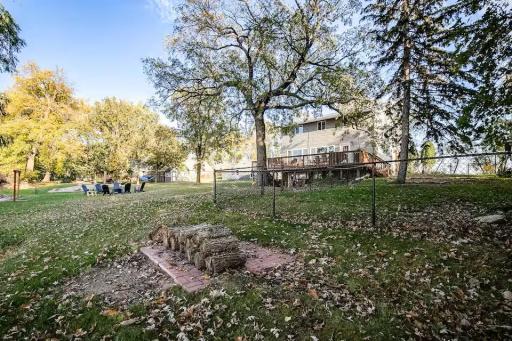A peaceful lakefront setting with mature trees, outdoor gathering areas, and plenty of room to enjoy the property.