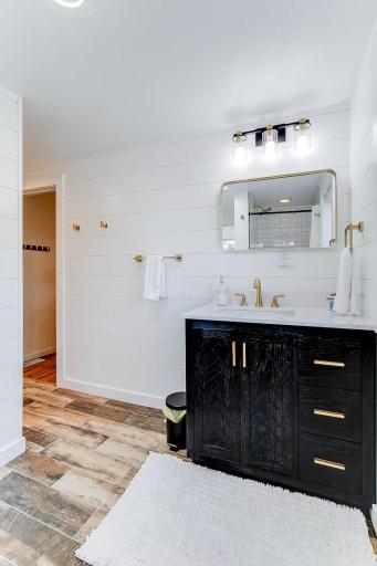 Freshly remodeled upper bath features a sleek vanity and updated fixtures.