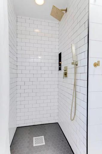 Tiled walk-in shower adds a polished touch to this remodeled bath.