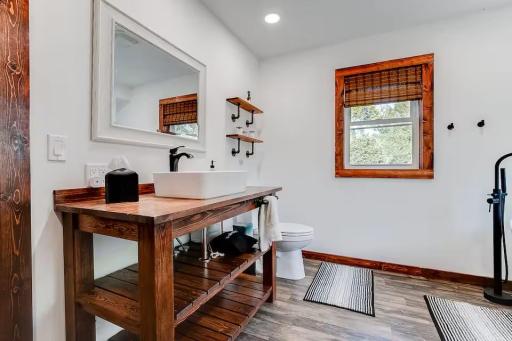 Warm wood vanity brings character and charm to this updated bathroom.