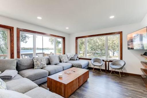 Sun-filled living room surrounded by windows.