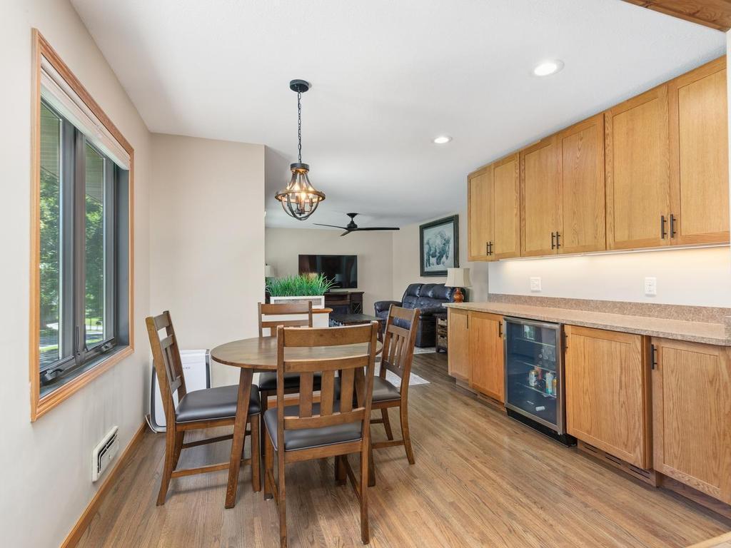 The dining area features a large window and additional storage cabinetry.