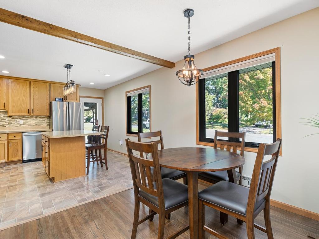 The dining area sits just off the kitchen, with a large window overlooking the yard.