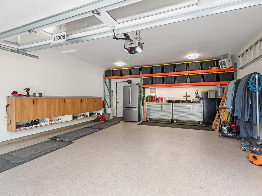 The heated two-car garage offers built-in storage and room for a work area.