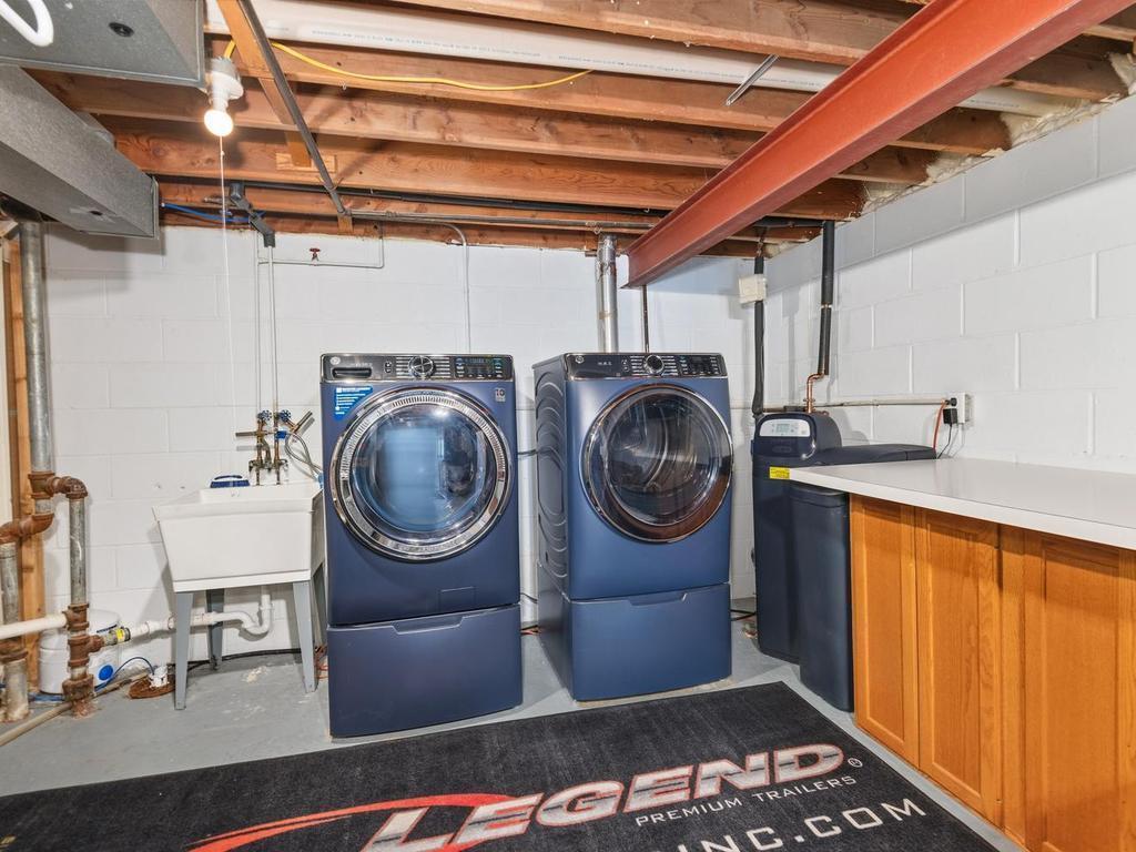 The laundry area includes a utility sink and additional counter space.
