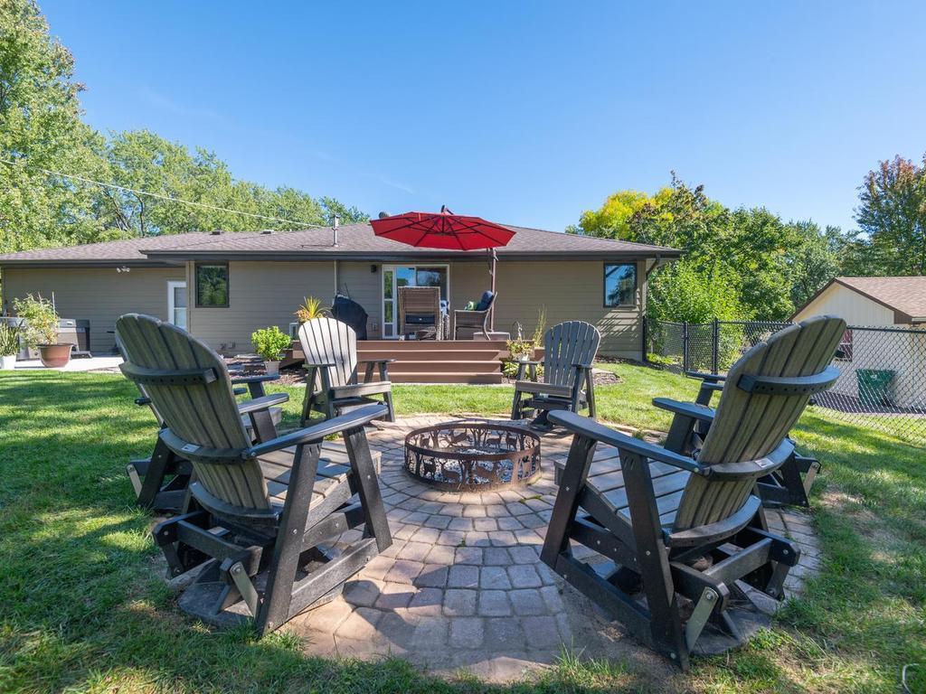 Gather around the fire pit in the fenced backyard.