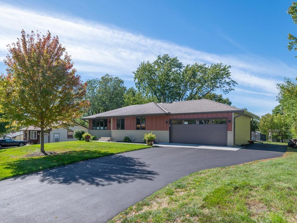 The extended driveway provides convenient additional parking alongside the two-car garage.