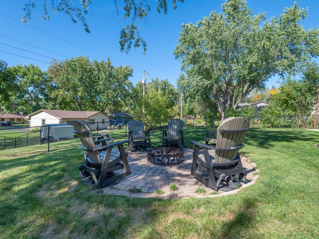 Gather around the fire pit in the fenced backyard.