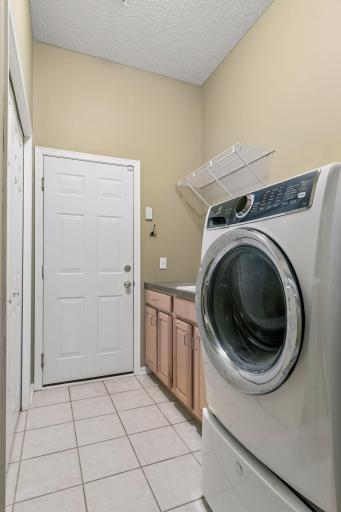 Newer laundry appliances in the laundry room.