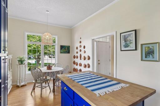 The center island is the perfect work station or gathering place, and there is even a eat-in space by the window.