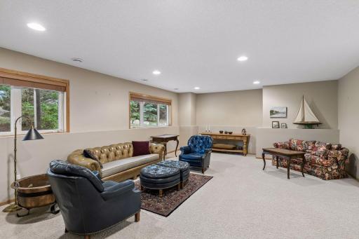 Large family room with ample light from large windows.