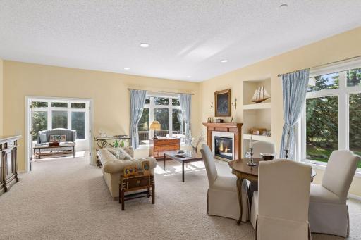 A massive living room with soaring ceilings and light-filled windows.