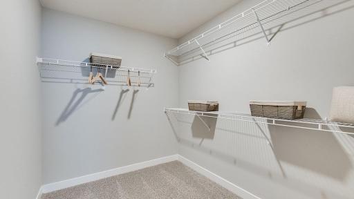 Spacious primary bedroom walk-in closet! Photos of model home. Colors and options may vary. Ask Sales Agent for details.