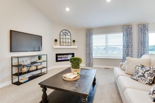 An electric burning fireplace completes the ambiance. Photo of Model Home. Options and colors may vary. Ask Sales Agent for details.