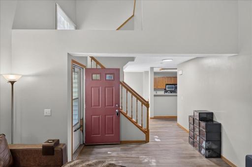 Freshly updated interior with new LVP flooring and an open, airy two-story design.