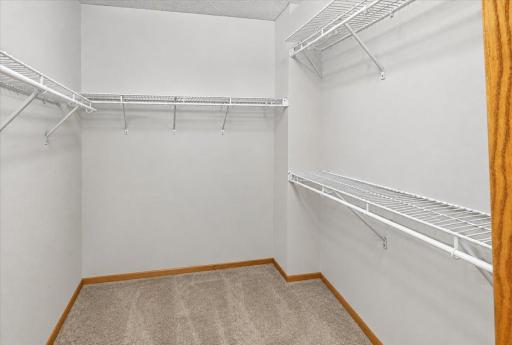 Large walk-in closet provides plenty of shelving and storage space.