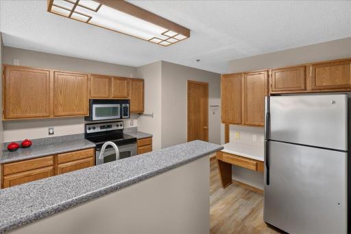 Spacious kitchen offers abundant cabinetry, generous counter space and a convenient built-in workspace.