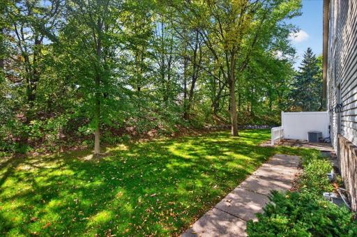 Enjoy a peaceful, wooded setting with mature trees and green space just outside your door.
