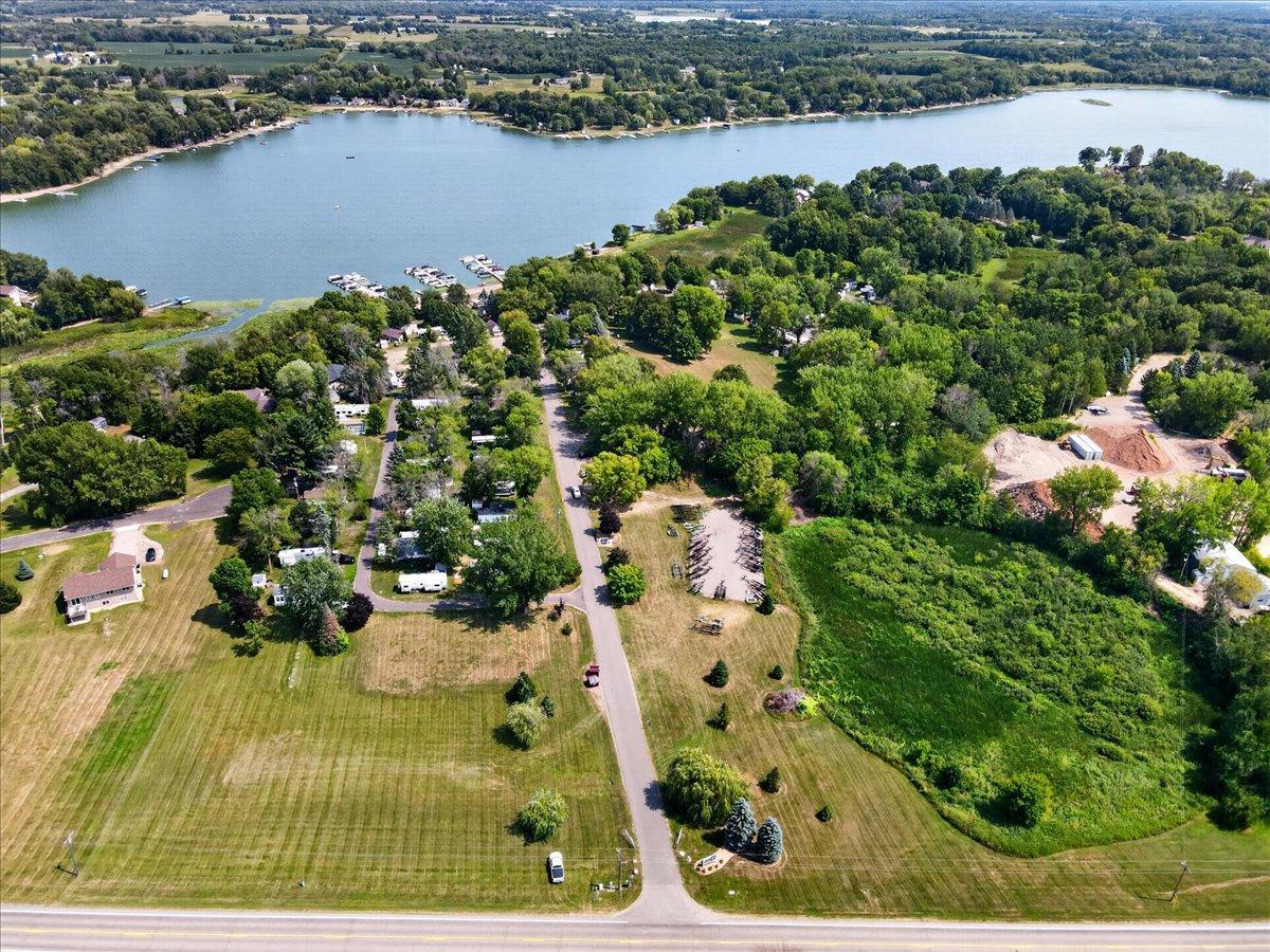 Expansive aerial view showcases the approximately 23-acre property and its beautiful lakeside setting.