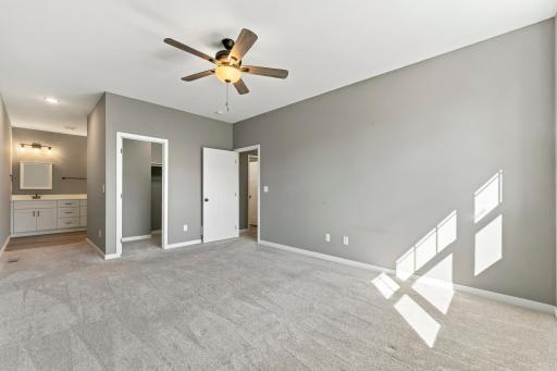 Primary bedroom has a walk-in closet and a private three-quarter bath