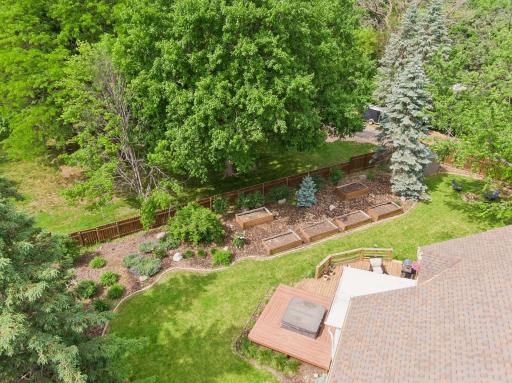 Garden beds have been used for vegetables, herbs, fruits and flowers - a good mix of sun and shade. You can see the edge of the screen porch adjacent to the hot tub and other outdoor gathering areas.