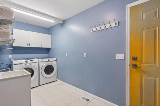 Spacious mud room / laundry room has lots of storage and a shop sink,