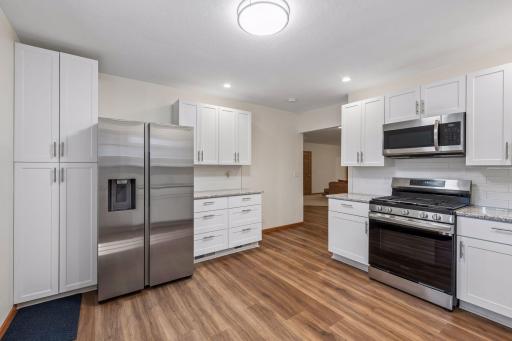 The kitchen has lots of cabinets and drawers for cooking tools. Nice stainless appliances and is adjacent to the living room.