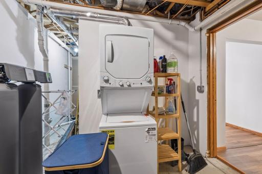 There is a stackable laundry unit in the basement utility room.