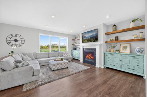 Comfortable Gathering Space with Open Views, Gas Fireplace, and Modern Design Custom Cabinets to Stay with the Home.