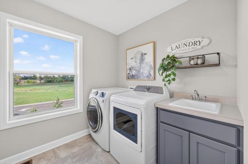 Spacious Upper Level Laundry Room with Convenient Storage, Laundry Sink, and Workspace; with Fam Views.