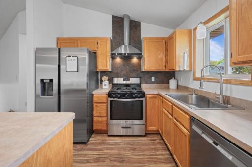 A striking range hood and gas range set the stage for serious cooking!