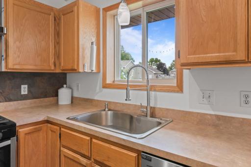 Note pull down faucet and offset single sink.