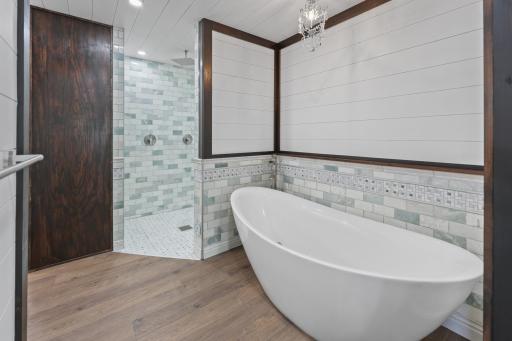 Relax and recharge in the custom ensuite, complete with a freestanding double soaking tub and separate walk-in shower1