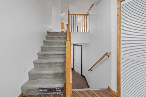 New carpet on stairs still has protective plastic on it.