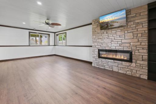 White wood-clad ceilings, recessed lighting, and thoughtfully placed windows create a bright, welcoming lower level.