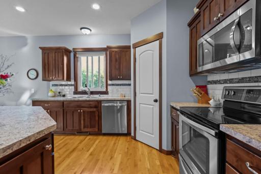 Beautiful kitchen with natural hardwoods and walk in pantry.JPG