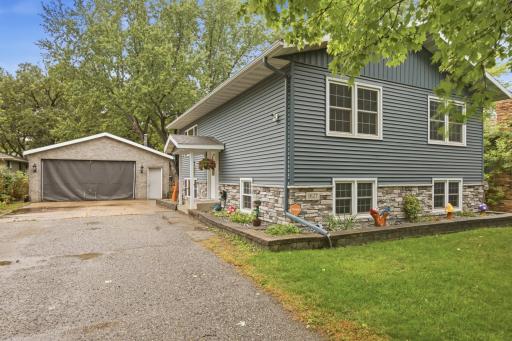 Stone accents complement the vinyl siding, while the architectural shingles, seamless rain gutters, fascia, and soffits were updated in 2019.