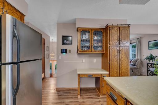 Oak cabinetry and a built-in desk that might make a good coffee or charging station.